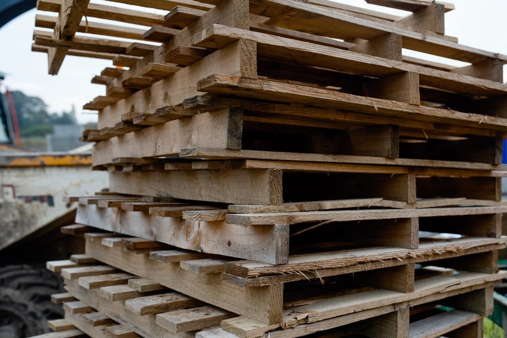 old-used-empty-wooden-pallets-stored-construction-site-min